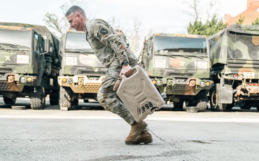 Strickland runs with the water cans.